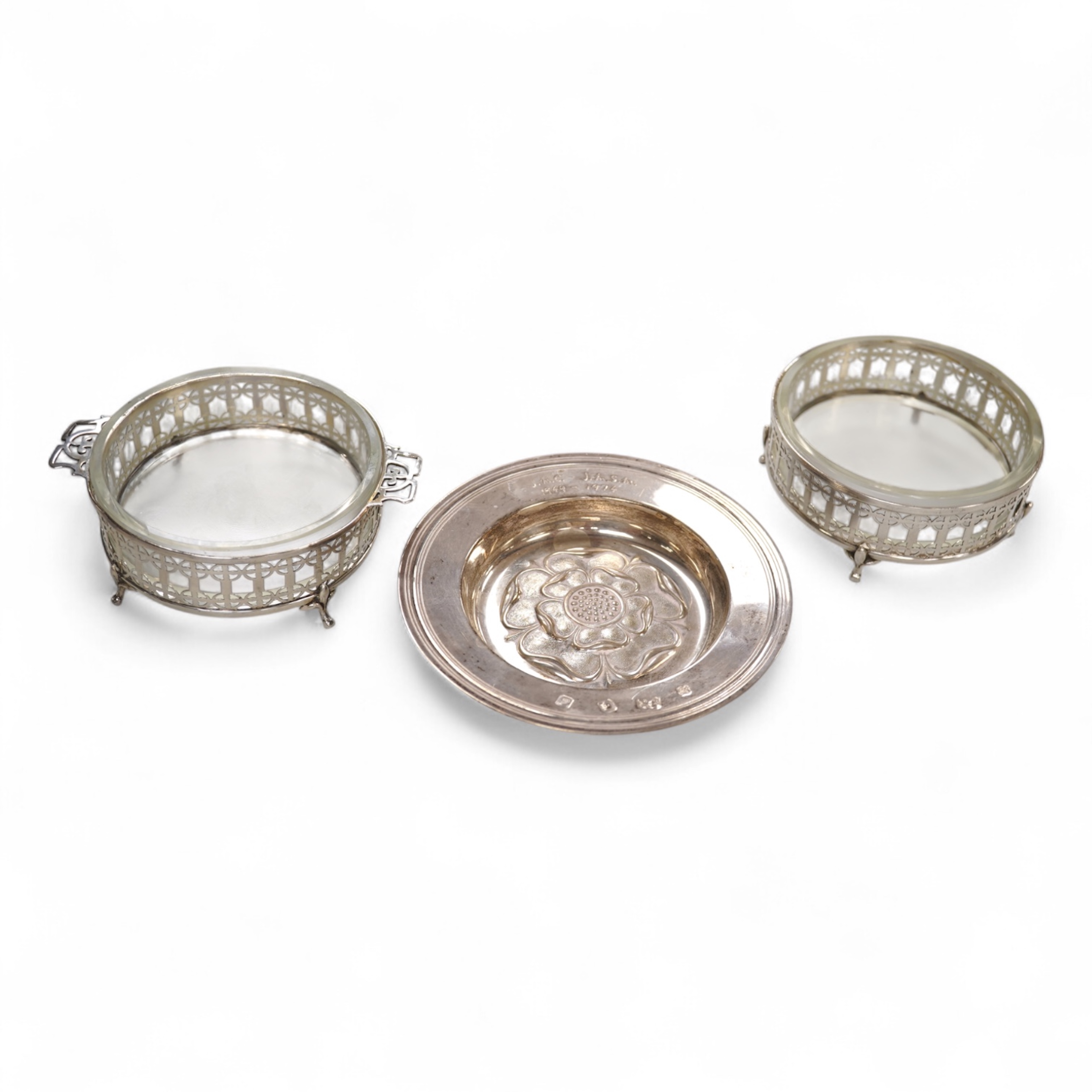 A 1970's silver 'Tudor Rose' dish, by Asprey & Co Ltd, diameter 11.8cm, together with a pair of George V silver mounted glass butter dishes.